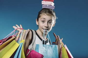 Young shopper balancing gifts and bags: a portrait of consumeris