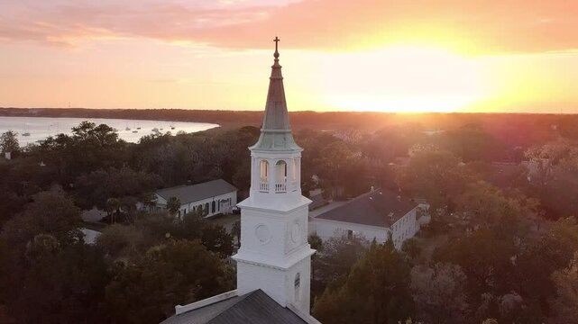Circling aerial view of historic church steeple at sunset in Beaufort, South Carolina