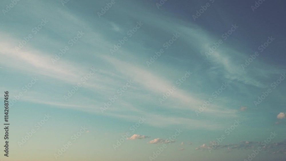 Poster Witness a stunning retro sunset as the sky transforms into vibrant hues, highlighted by soft clouds drifting throughout. Tranquil atmosphere evokes a sense of peace and reflection. Time lapse motion.