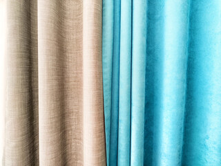 Elegant fabric curtains in shades of beige and turquoise creating a modern aesthetic for interior...