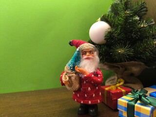 New Year Santa Claus near the Christmas tree.