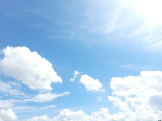 White clouds and blue sky with sunlight add to the beauty of the universe