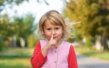 A child picks his nose with his finger. Selective focus.