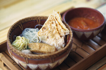 Malang Meatballs Served in a Rustic Bowl With Spicy Sauce In Rustic Setting