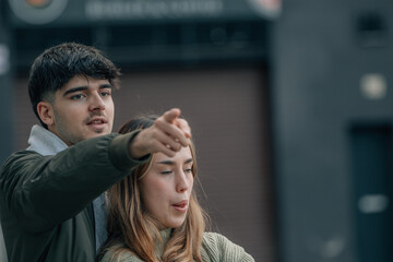 young couple in love hugging on the street