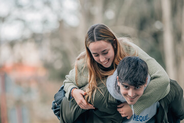 young couple in love hugging on the street