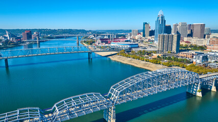 Naklejka premium Aerial of Cincinnati Skyline and Roebling Bridge Over Ohio River