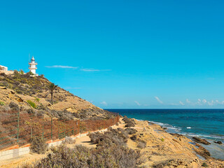 Lighthouse Overlooking Coastal Hills and Sea. Alicante, Spain