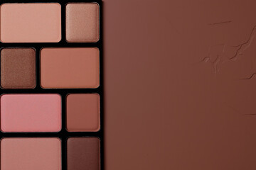 Fototapeta premium shiny eyeshadow palette featuring muted mocha mousse and brown with neutral tones