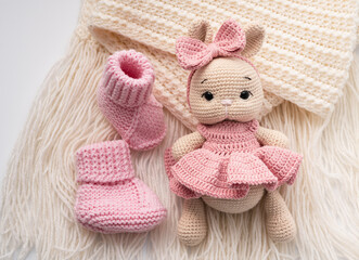 Variety of knitted toys. Bunny and baby booties. Handmade soft toys.