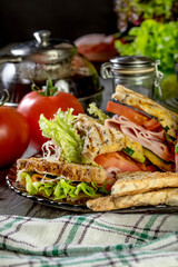 Panini sandwich with ham, tomato and lettuce.