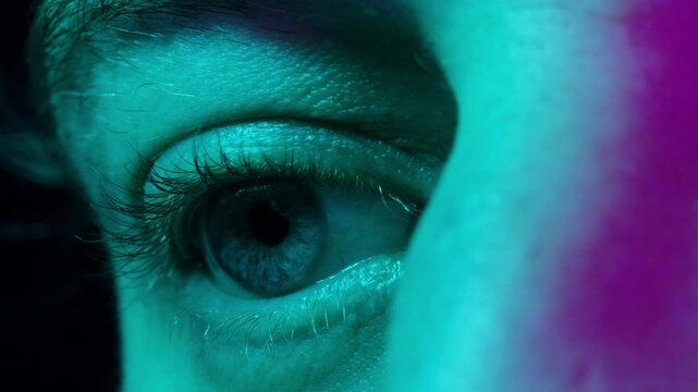 Detailed blue eye with strong gaze, showing human anatomy and beauty, thriller depression halloween style. Drugs concept.