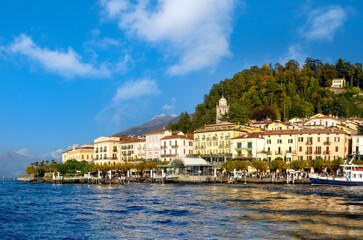 The photogenic lake front promenade and pier of the the village of Bellagio on the shores of lake Como, Lombardy, Italy.