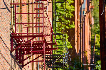 Red Fire Escapes on Brick Building with Low Angle Geometry