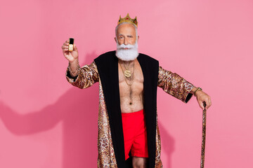 Portrait of confident aged man wear leopard coat halloween costume hold show cellphone stick isolated on pink color background