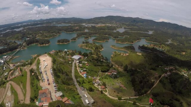 A wide view looking down at lakes, islands, and houses from the top of Guatap&eacute; Rock in Columbia