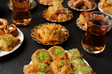 Delightful assortment of sweets and tea served on decorative plates in a warm setting