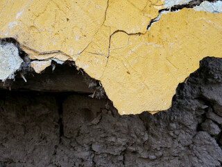 broken yellow painted wall of old house