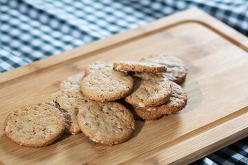 A delightful display of freshly baked  cookies arranged on a wooden cutting board 