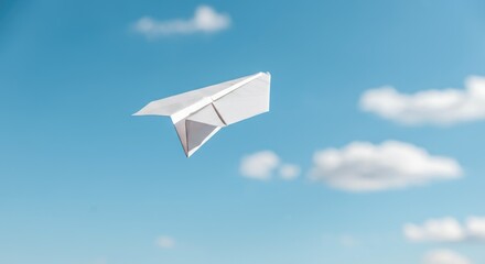 White paper airplane flying through bright blue sky with some clouds