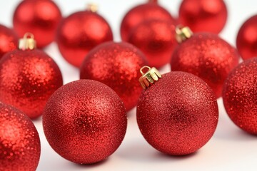 Group of bright red Christmas ornaments on a white background