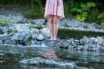 bare girl's feet with an ankle chain, standing on a stone shore, on stones in the water, pink dress, purple veil, river, transparent, mountain, water, nature, flow, reflection, design, fashion, travel