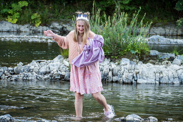blond girl, a teenager, in a sweater and a summer dress, in a white paper crown, 
 with purple...