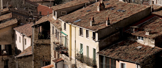 Red tile roofs and chimneys in a French mountain village near the Maritime Alps