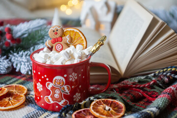 New Year 2025, tea with orange, coffee with marshmallows, books and fir branches, New Year's toys and a ball on the table.