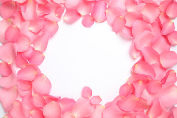 Frame made of pink rose petals on white background, top view