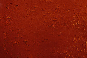 Abstract background of old red paint on the wall.
