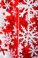 A detailed view of delicate snowflakes against a bright red backdrop