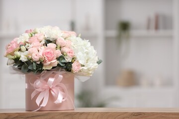 Beautiful bouquet in box on table at home. Space for text