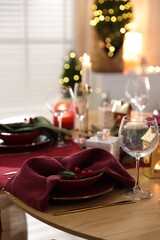 Christmas table setting with stylish dishware and festive decor indoors