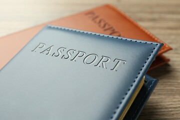 Passports in color covers on table, closeup