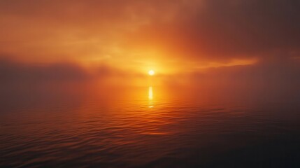 Obraz premium mysterious sunset shrouded in fog, where warm orange hues blend with soft, gray mist, creating a tranquil scene that evokes contemplation of nature's beauty