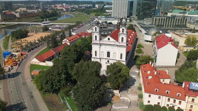 Drone pullback view revealing the church of St Raphael the Archangel with the river and buildings