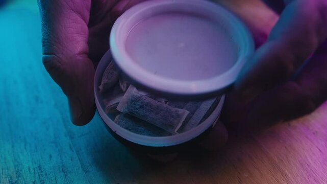 Snus nicotine tobacco close up, pack of tobacco for gum. unhealthy addiction.
