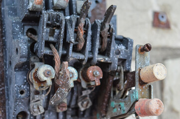an old broken switch mechanism in which the insides with small wires, bolts and other electrically...