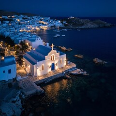 Fototapeta premium Nighttime drone shot of iconic Paraportiani chapel near Little Venice in Mykonos.