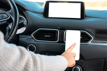 A female driver using a phone navigator in the car,