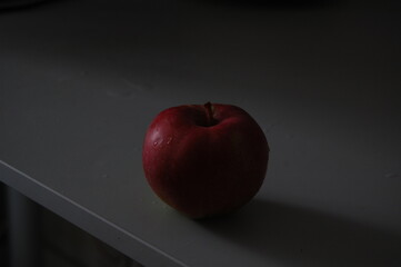red apple on black background