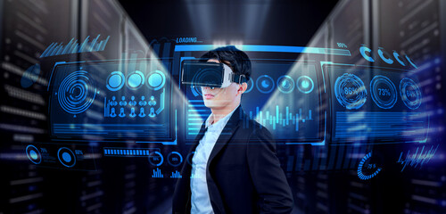 Businessman with headset standing at data center while analyzing financial data. Manager looking marketing statistic hologram and using augmented reality goggles while making a decision. Ingenuity.
