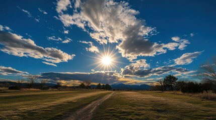 vivid imagery of sun and clouds in a bright blue sky, capturing the essence of a beautiful day filled with light and warmth