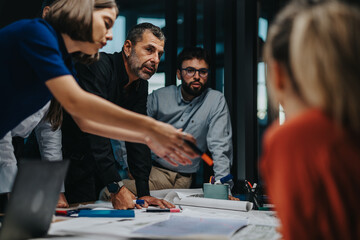 A diverse group of business people collaborating on a project. They are engaged in a brainstorming session, focusing on teamwork and creativity in a modern office environment.