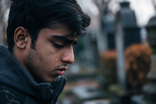 Generative AI image of mourning young man in cemetery grief and respect for dead person