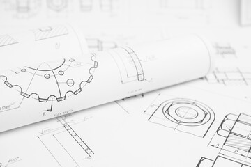 paper engineering drawings of industrial parts and mechanisms