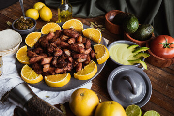 meat mounted on yellow lemon slices and garnishes