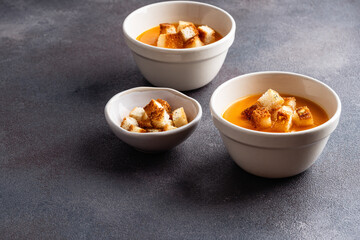 Butternut squash soup with bread croutons in  ceramic bowl