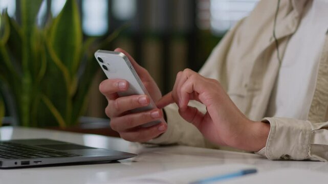Close up unrecognizable businessman worker business man guy male hands holding mobile phone at desk hold smartphone texting message in web chat surfing corporate network reading news work online using